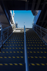 Stairs in a ship, bottom view with sky background