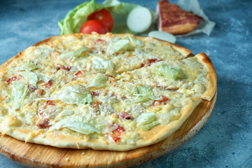 Slice of hot pizza large cheese lunch or dinner crust seafood meat topping sauce. with bell pepper vegetables delicious tasty fast food italian traditional on wooden board table classic in view