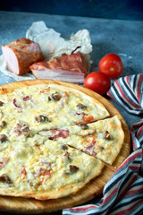 Slice of hot pizza large cheese lunch or dinner crust seafood meat topping sauce. with bell pepper vegetables delicious tasty fast food italian traditional on wooden board table classic in view