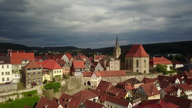 Kronach medieval walled town and castle with red roofs and historic houses in Franconia, Bavaria Germany with dramatic stormy sky on a summer afternoon