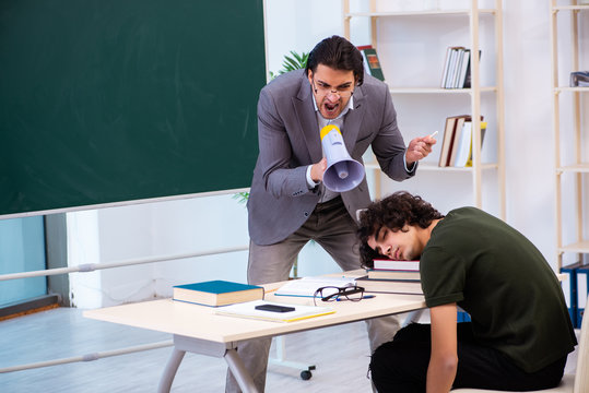 Young Teacher And Student In The Classroom 