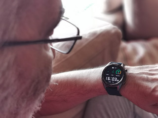 Old White Man Looking at his smart watch