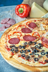 Slice of hot pizza large cheese lunch or dinner crust seafood meat topping sauce. with bell pepper vegetables delicious tasty fast food italian traditional on wooden board table classic in view