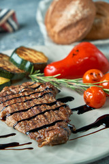 grilled beef steak with vegetables on plate