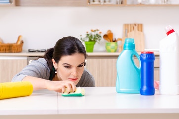 Young female contractor doing housework 