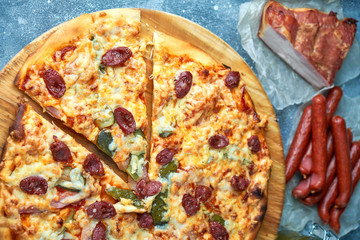 Slice of hot pizza large cheese lunch or dinner crust seafood meat topping sauce. with bell pepper vegetables delicious tasty fast food italian traditional on wooden board table classic in view