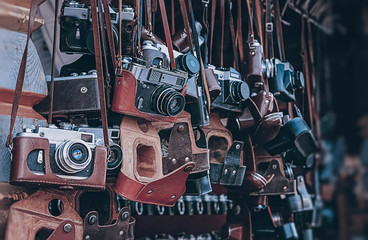 old vintage cameras at flea market. Collection of antique retro-film analog cameras. many kinds of different undefined model vintage photocameras. close up. soft selective focus - Powered by Adobe