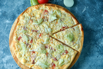 Slice of hot pizza large cheese lunch or dinner crust seafood meat topping sauce. with bell pepper...