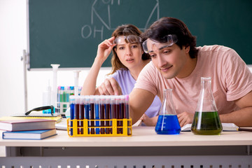 Two chemists students in classroom 