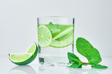 Coctail with lime and fresh mint on white background