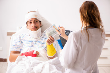 Young doctor examining injured patient 