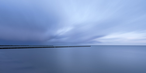 Dark blue thunderstorm clouds are drifting across the Baltic Sea.