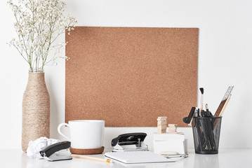 Cork board with office supplies, cup and plant in bottle vase on white background. Home   office workplace