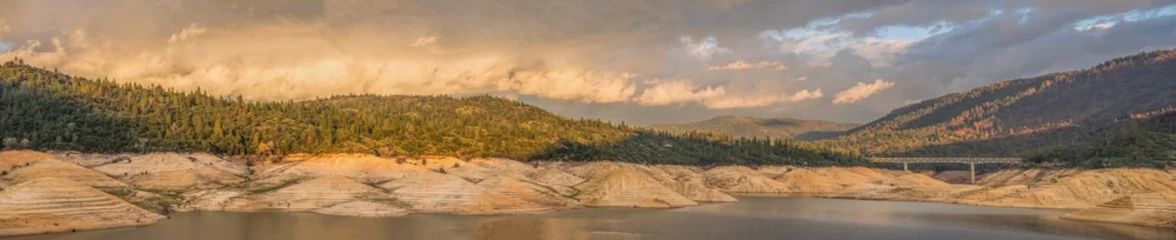 Poster Panoramic landscape of storm clouds passing over Lake Oroville in Northern California after a drought that caused low water. © Ben