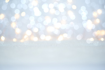 Magic twinkling holiday abstract glitter background with blinking lights and snow. Blurred bokeh of...