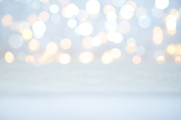 Snow and lights. Empty space white snowy table. Christmas card.