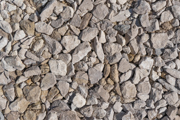 Stone rock background texture, gray stone road. Rubble, macadam background texture close up. Garden rubble road top view
