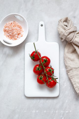 cherry tomatoes and himalayan salt on marble background