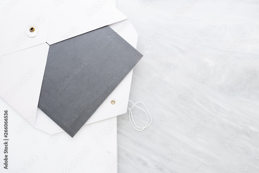 Poster Top view of blank grey card in white envelop on two layer step of marble table top.Mock up template for display of design.business items.