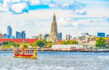 View  of   Wat Arun Ratchawararam Ratchawaramahawihan temple  and The Royal Barge Suphannahong Suphan Swan boat or Suphannahong boat in Chao Phraya river at Bangkok Thailand