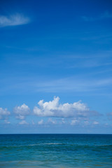 Naklejka na ściany i meble Clouds blue sky and calm sea background landscape