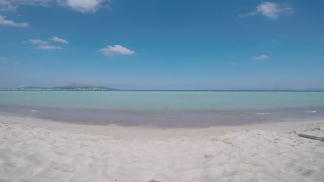 vista frontal de la playa de muro en mallorca viendo las olas rompiendo en la orilla