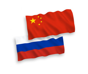 National vector fabric wave flags of Russia and China isolated on white background. 1 to 2 proportion.