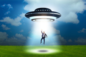 Flying saucer abducting young businessman 