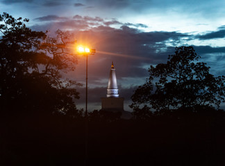 White top of a stupa of Ruwanwelisaya and streetlight