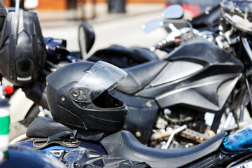 Fototapeta na wymiar Motorcycle helmet rests on the seat of a motorcycle