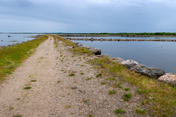 Fototapeta na wymiar Big Solovetsky dam connecting the island the Big Solovetsky island with large Muksalma. Length 1200 meters, base width 7 meters