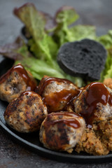 Closeup of roasted truffles made of mushrooms and cheese, selective focus, vertical shot