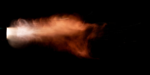 Texture of firearm shot with bright flash of light, sparks, smoke and gunpowder gases on black...