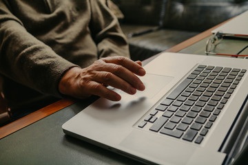 Male hand controls computer touchpad