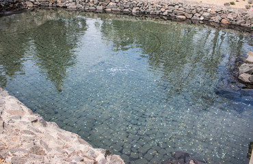 a lake with a rocky bottom filled with coins.