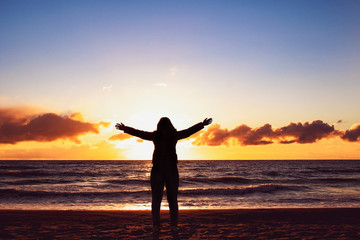 silhouette of a girl at sunset. silhouette says goodbye to the sun.