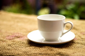 White coffee mug on the sack, blurred background