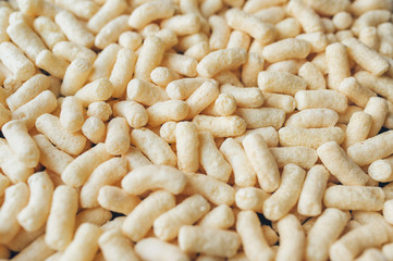 Background of yellow corn sticks. Dietary breakfast concept. Close up.