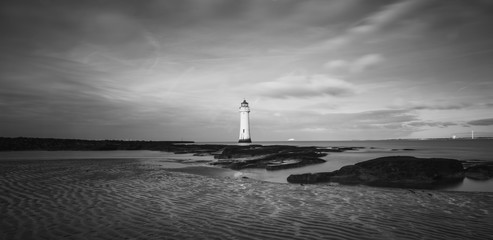 lighthouse at sunset in black and white