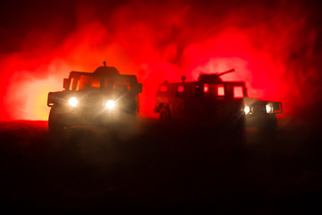 Obraz premium War Concept. Military silhouettes fighting scene on war fog sky background, Fighting silhouettes Below Cloudy Skyline At night. Battle scene. Army vehicle with soldiers. army