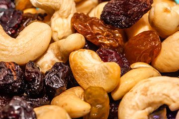Close up of a mixed of nuts, dry fruits and chocolate