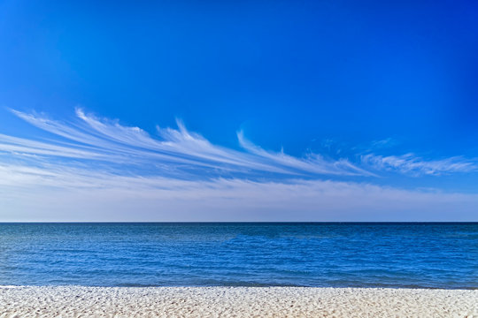 Blue sky cirrus clouds sea panorama.