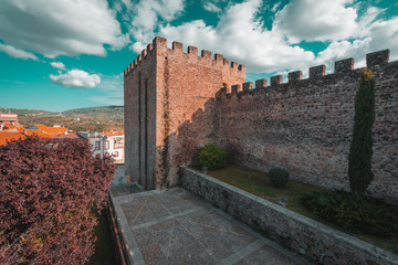 Fototapeta na wymiar Torre Lucia defensive tower and medieval walls of Plasencia, walled market city in the province of Caceres, Spain. Teal and orange style