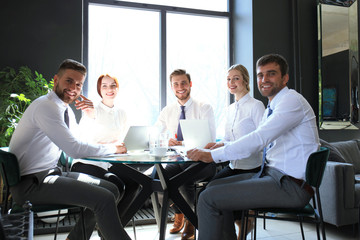 Portrait of a positive business employees at an office business meeting.