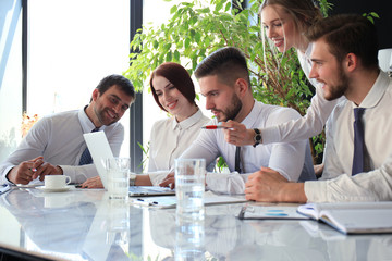 business team working on laptop to check the results of their work.