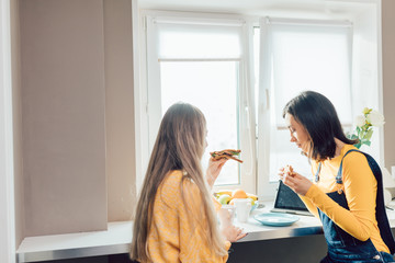 two hungry girls having breakfast, having a snack before going to work. fast food.people concept, close up photo