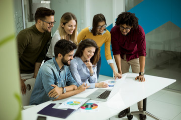 Group of young multiethnic business people working and communicating together in creative office