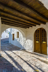 Street view of Plaka picturesque village with paved alleys and traditional houses in Milos island in Cyclades, Greece