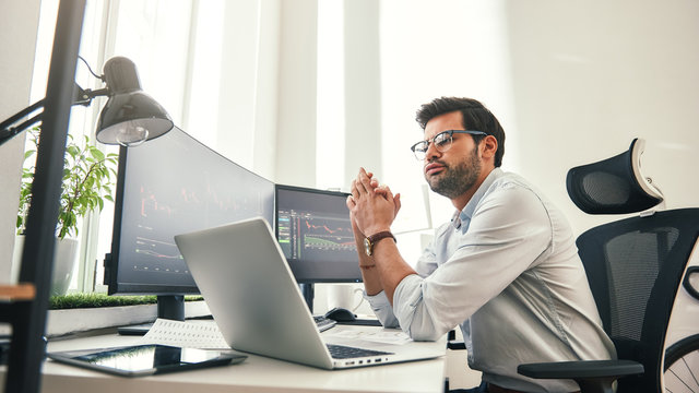 So tired. Side view of exhausted young beard businessman or trader in formal wear and eyeglasses feeling tired after long working day in office.
