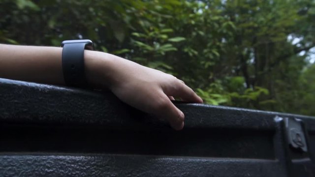 Hand of an asian guy tapping for the beat of the song he listen in the forest. refreshing himself. good mental health.